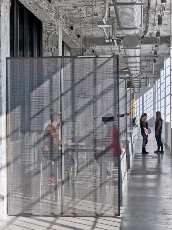 TPG Architecture retained the grand proportions of a 1930s tobacco factory in this adaptive-reuse project for an American advertising agency. Transparent partitions maintain an open-plan feel. Photos: Eric Laignel