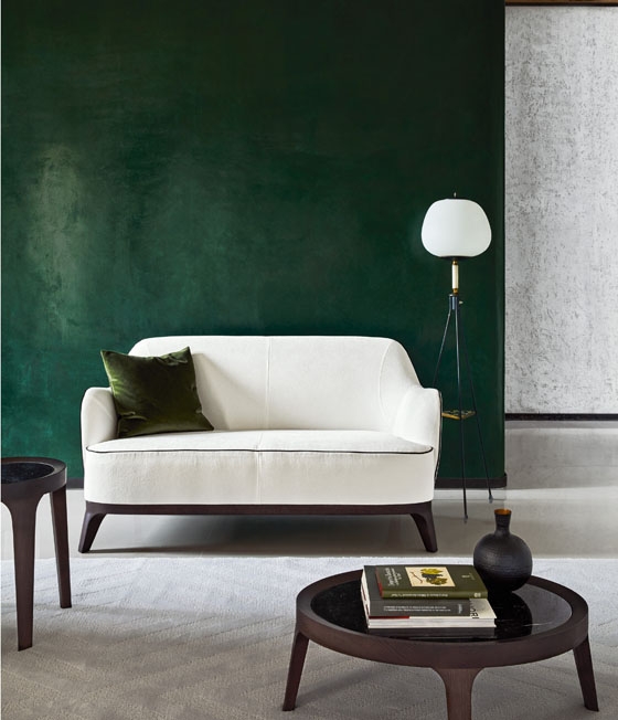 Roberto Lazzeroni’s Lysandre sofa comes with ecru upholstery and contrasting piping, and rests on splayed wooden legs. Its midcentury character is enhanced when combined with 1950s-style lighting