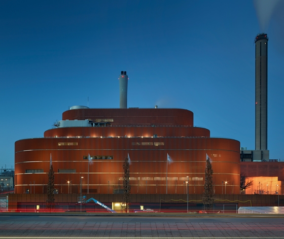 The Värtaverket biomass power plant in Stockholm is one of the largest in the world. Brick-coloured slats allow for variable positioning of openings in the building envelope. Photographer: Robin Hayes