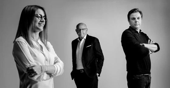 Top: The CCube – Cleaf's architect-designed showroom, which offers visitors an immersive, surface-rich experience. Above: Cleaf founder Luciano Caspani (centre), pictured with his daughter Barbara and his son Roberto