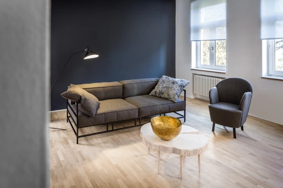 The black to grey colour gradient emphasises the contrast between the cool metal and the soft, warm wool felt. Instead of cuboid armrests, this sofa features two decorative large cushions. Photograph: Michael Danner