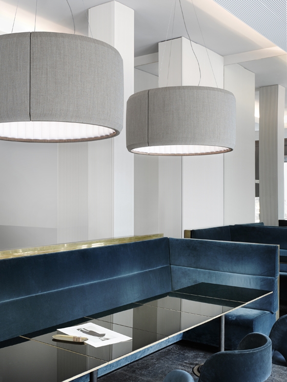 The circular Silenzio light features an external skin of beautiful Kvadrat fabric, allowing designers to complement bold or muted interior colour palettes with their lighting choices
