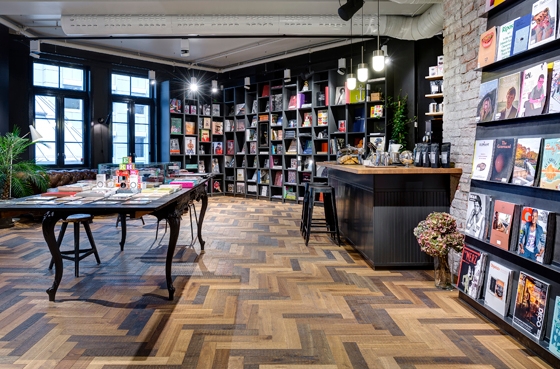Unique flooring creates connections between a bookstore and a café at the YME Universe in Oslo. ©YME Studios